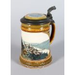 A GOOD METTLACH POTTERY TANKARD, decorated with a hillside view with river No: 2277 5.5in high