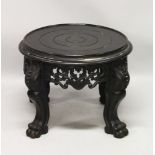A 20TH CENTURY CHINESE BLACK LACQUER CIRCULAR STAND, with a pierced and carved frieze on four carved