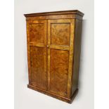 A VICTORIAN FIGURED WALNUT WARDROBE, with a moulded cornice over a pair of panelled doors
