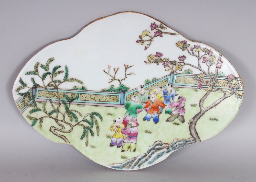 A CHINESE FAMILLE ROSE QUATREFOIL PORCELAIN BOYS PLAQUE, 14.5in x 10.1in at widest points.