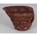 A 19TH CENTURY CHINESE CARVED BAMBOO LIBATION CUP, carved in deep relief with a scene of a sage