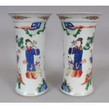 A MIRROR PAIR OF CHINESE KANGXI STYLE FAMILLE VERTE PORCELAIN BEAKER VASES, each base with a six-