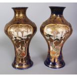 A PAIR OF SIGNED JAPANESE MEIJI PERIOD SATSUMA EARTHENWARE VASES, each painted with panels of ladies