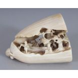 AN UNUSUAL JAPANESE IVORY OKIMONO OF A FRUIT POD, the interior to reveal a 'dream' of diminutive