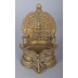 A 19TH/20TH CENTURY SOUTH INDIAN BRONZE OIL LAMP, the vertical plate cast with Lakshmi and two