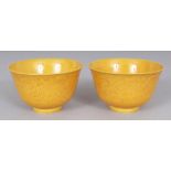 A PAIR OF YELLOW GLAZED PORCELAIN DRAGON TEABOWLS, each with underglaze incised decoration, each