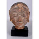 A Carved Wood Female Head, Orissa, Eastern India, 19th century, with raised eyebrows, headband and