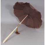A GOOD QUALITY EARLY 20TH CENTURY CHINESE PARASOL, the collapsible ivory handle carved with vine,