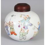 A CHINESE HONGXIAN MARK & PERIOD FAMILLE ROSE PORCELAIN JAR, with a fitted pierced hardwood cover,