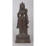 A 19TH CENTURY INDIAN BRONZE FIGURE OF A STANDING FEMALE DEITY, supported on a lotus plinth above