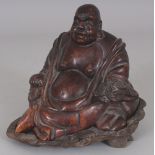 A 20TH CENTURY CHINESE BROWN STONE CARVING OF BUDAI, together with a fitted wood stand, the stone