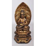 AN EARLY 20TH CENTURY JAPANESE LACQUERED WOOD FIGURE OF BUDDHA, seated in meditation on a stepped