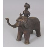 A 20TH CENTURY INDIAN BRONZE MODEL OF AN ELEPHANT, bearing a rider on its back, 6.75in long & 6in