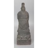 A CHINESE BLACK FINISHED RED POTTERY FIGURE OF A STANDING EMPEROR, the plinth incised 'The Emperor