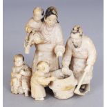 A SIGNED JAPANESE MEIJI PERIOD IVORY OKIMONO OF A FAMILY GROUP, of a father, mother, three