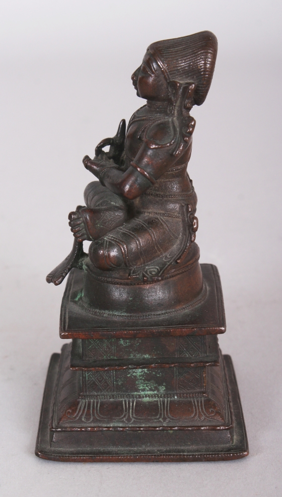 A Bronze Figure of a Tamil Saint, South India, 18th/19th century, seated in sattvasana on a raised - Image 4 of 8