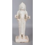 AN 18TH/19TH CENTURY INDIAN CARVED WHITE MARBLE FIGURE OF LAKSHMI, standing on a rectangular plinth,