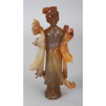 A CHINESE AGATE FIGURE OF GUANYIN, the Goddess standing in flowing robes and bearing floral