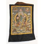 A TIBETAN PAINTED FABRIC HANGING THANGKA, with a protective hanging silk canopy, the thangka