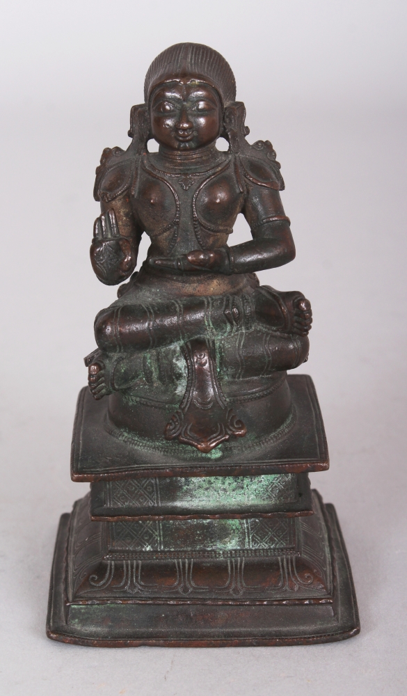 A Bronze Figure of a Tamil Saint, South India, 18th/19th century, seated in sattvasana on a raised