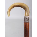 A HORN HANDLED MALACCA WALKING STICK, with an embossed and faintly hallmarked silver collar, the