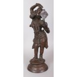 A LARGE 19TH/20TH CENTURY INDIAN BRONZE FIGURE OF A STANDING FEMALE DEITY, examining her features in