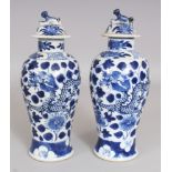 A SMALL PAIR OF 19TH CENTURY CHINESE BLUE & WHITE PORCELAIN DRAGON VASES & COVERS, each base with