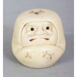 A SIGNED JAPANESE MEIJI PERIOD IVORY NETSUKE OF A DARUMA DOLL, with frowning expression, his mouth