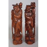 A PAIR OF EARLY 20TH CENTURY CHINESE WIRE INLAID CARVED HARDWOOD FIGURES OF IMMORTALS, 11in high.