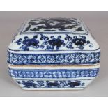 A CHINESE MING STYLE BLUE & WHITE CHAMFERED PORCELAIN DRAGON BOX & COVER, the base unglazed, 6.