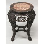 A SMALLER 19TH/20TH CENTURY CHINESE PINK MARBLE TOP CIRCULAR HARDWOOD STAND, with a pierced prunus