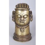 A Brass Lingam Cover, Western Deccan, India, 15th/16th century, in the form of a head of Siva,