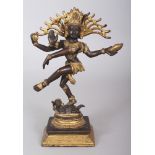 A 20TH CENTURY INDIAN GILT BRONZE FIGURE OF SHIVA DANCING ON A PROSTRATE APASMARA, 9.75in high.