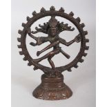 A 19TH/20TH CENTURY BRONZE FIGURE OF SHIVA, dancing within a flaming aureole, 4.1in wide at widest