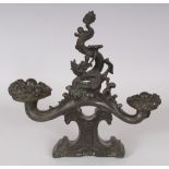 A CHINESE BRONZE ORNAMENT, cast in the form of a ruyi sceptre supported on a plinth and surmounted