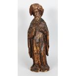 A 16TH-17TH CENTURY CARVED FRUITWOOD SAINT, carrying a book. 18ins high.