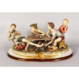 A SUPERB LARGE CAPODIMONTE PORCELAIN GROUP, four boys playing and cheating at cards, around a rustic