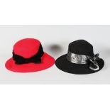 A RED YVES SAINT LAURENT HAT, size 57, and A BLACK HAT (2).