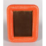 A CORAL COLOURED EASEL PICTURE FRAME. 16ins x 13ins.