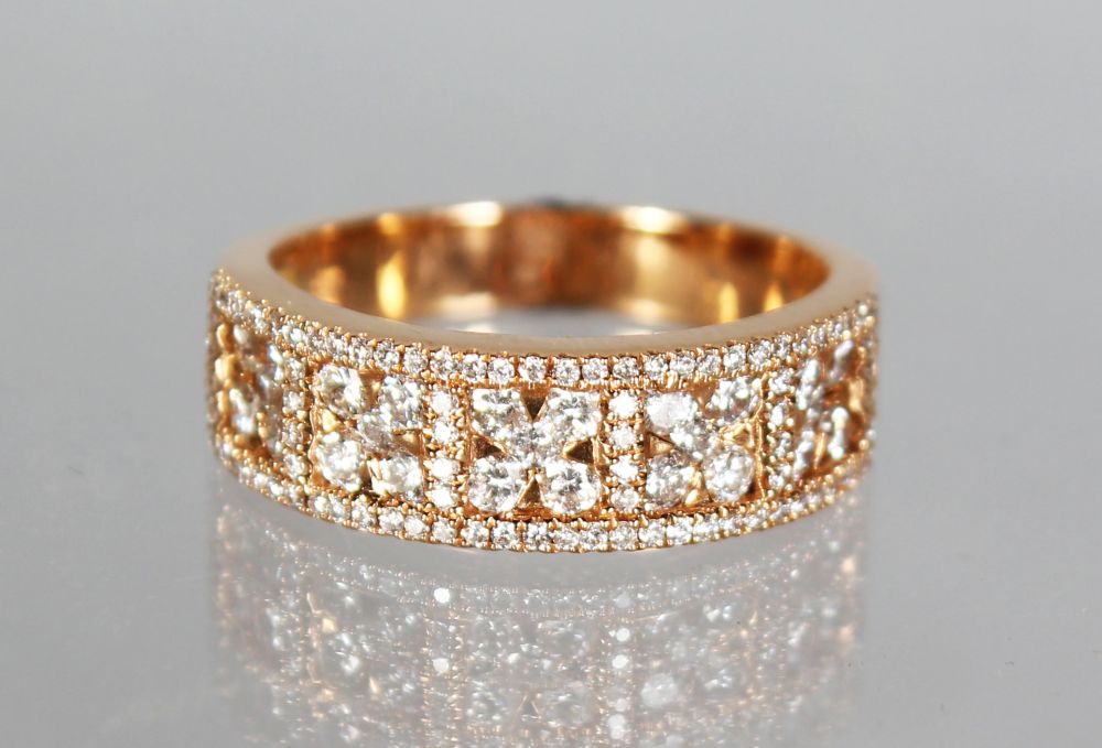 AN 18CT ROSE GOLD HALF ETERNITY RING of 75 points.