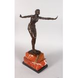 AN ART DECO STYLE BRONZE FIGURE OF A DANCER, arms outstretched, on a stepped marble base. 1ft 7ins