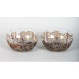 A PAIR OF CHINESE SILVER BOWLS, of pierced bamboo design, with glass liners. 4.5ins diameter.