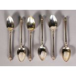 A SET OF SIX SILVER ENGRAVED TEASPOONS.