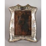 A SILVER PHOTOGRAPH FRAME, repousse with roses. Birmingham 1910. 8ins x 6ins.