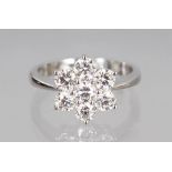 AN 18CT WHITE GOLD DAISY STYLE RING of 1.25cts, colour J, clarity VS.