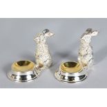 A PAIR OF NOVELTY SALTS, modelled as rabbits. 2.5ins high.