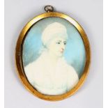 AN OVAL MINIATURE OF A LADY in white dress and bonnet. 3ins x 2.25ins.
