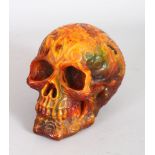 AN UNUSUAL AMBER STYLE MODEL OF A HUMAN SKULL. 5ins high.