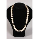 A GOLD PEARL NECKLACE with diamond section.