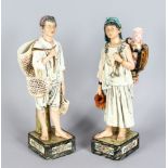 A PAIR OF CONTINENTAL MAJOLICA FIGURES, YOUNG BOY AND GIRL, The Water Carriers. 13ins high.